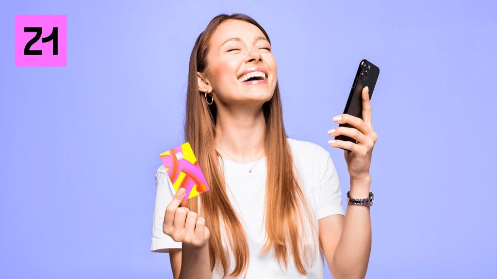 Adolescente com celular e cartão da Z1 nas mãos